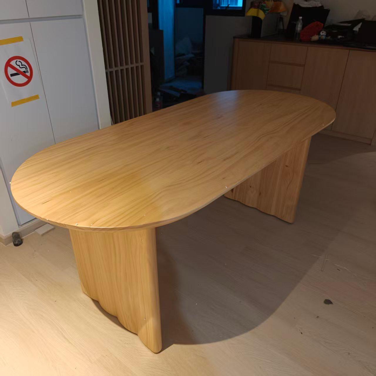 Oval wooden dining table assembled by The Good Guys Singapore.