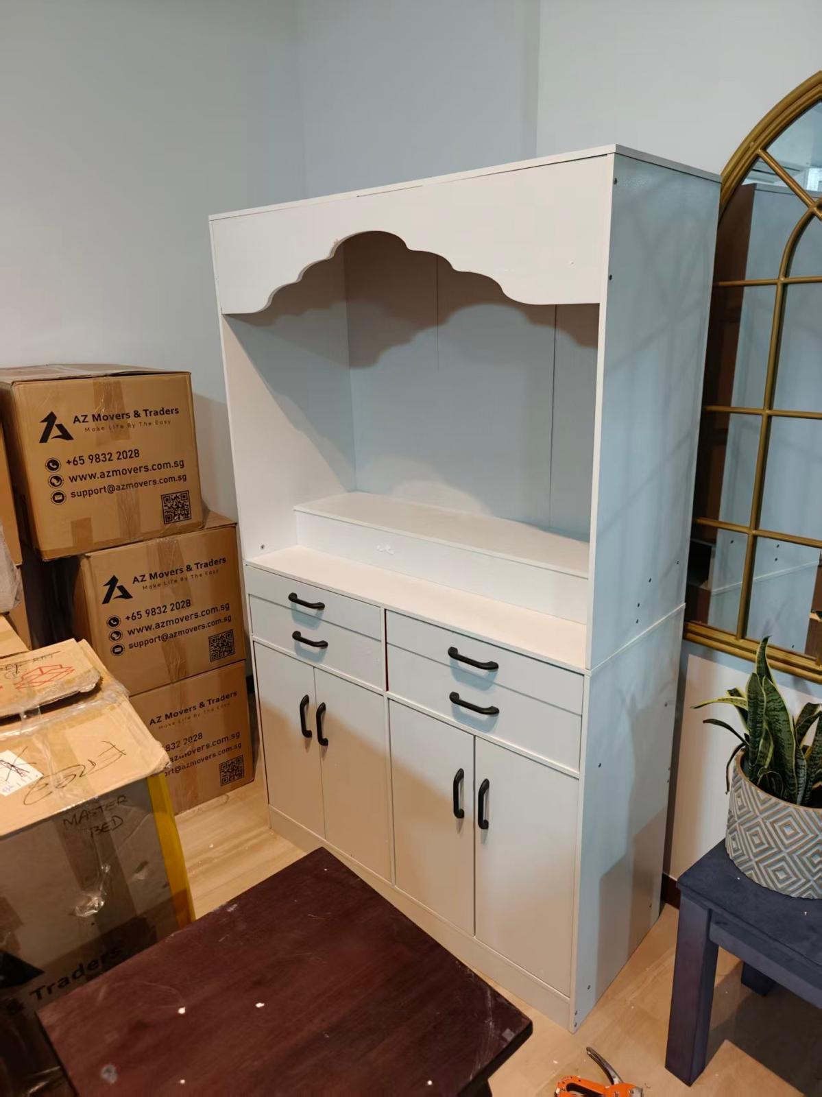 White altar cabinet with drawers and cupboards assembled by The Good Guys Singapore.