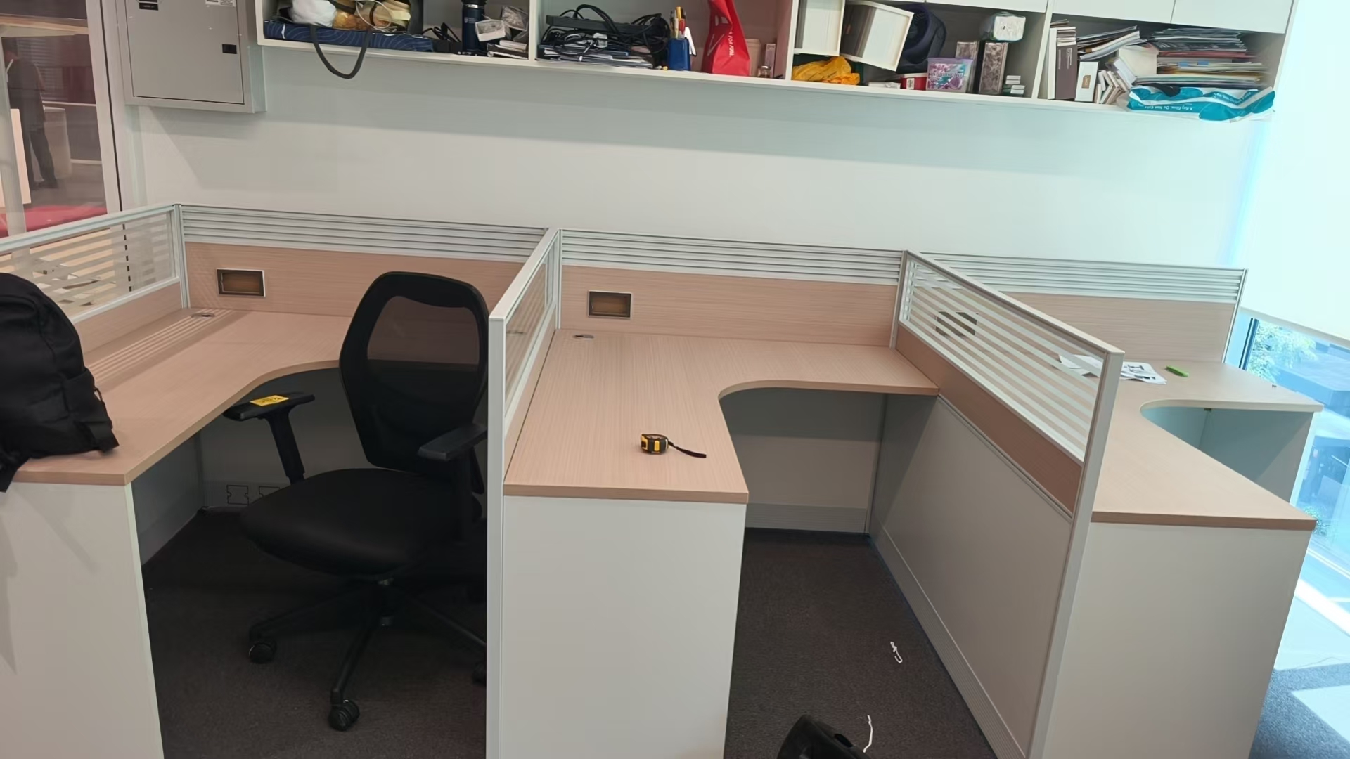 Partitioned office workstations with curved desktops assembled by The Good Guys Singapore.