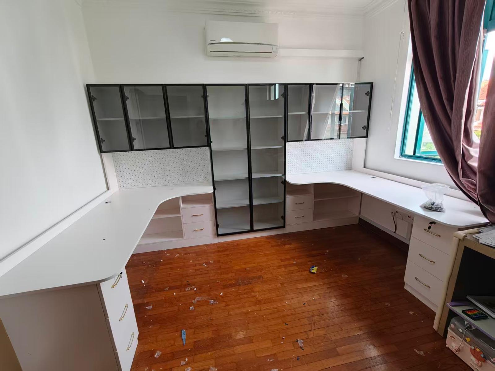 Wraparound work desk with drawers and glass-door display cabinets assembled by The Good Guys Singapore.