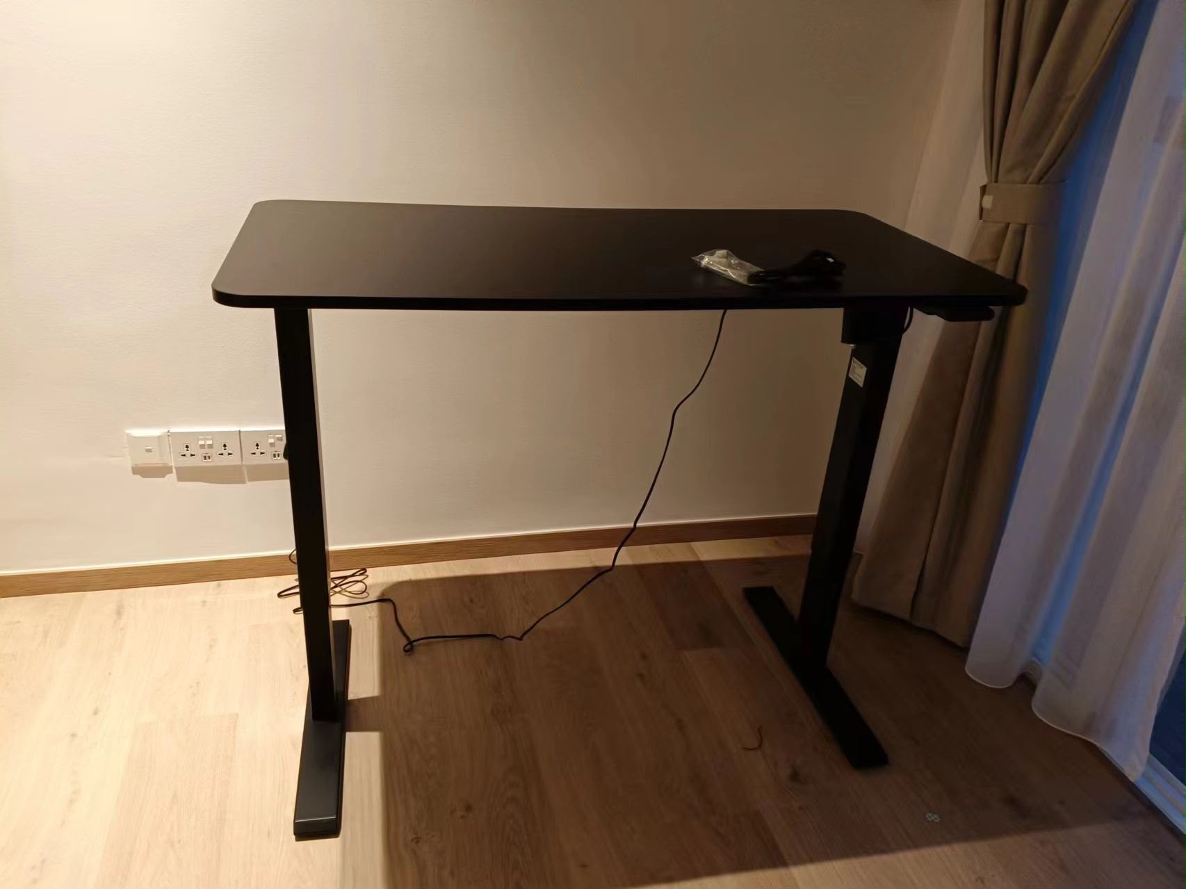 Electric height-adjustable standing desk assembled by The Good Guys Singapore.