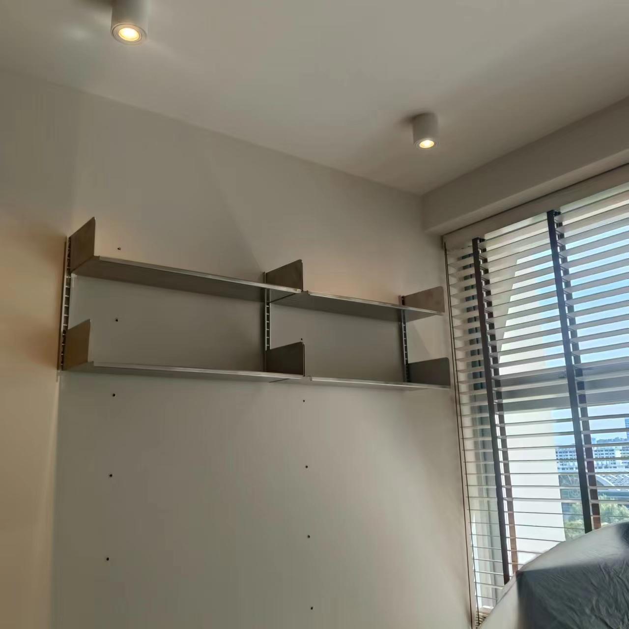 Wall-mounted display shelving installed at height by The Good Guys Singapore.