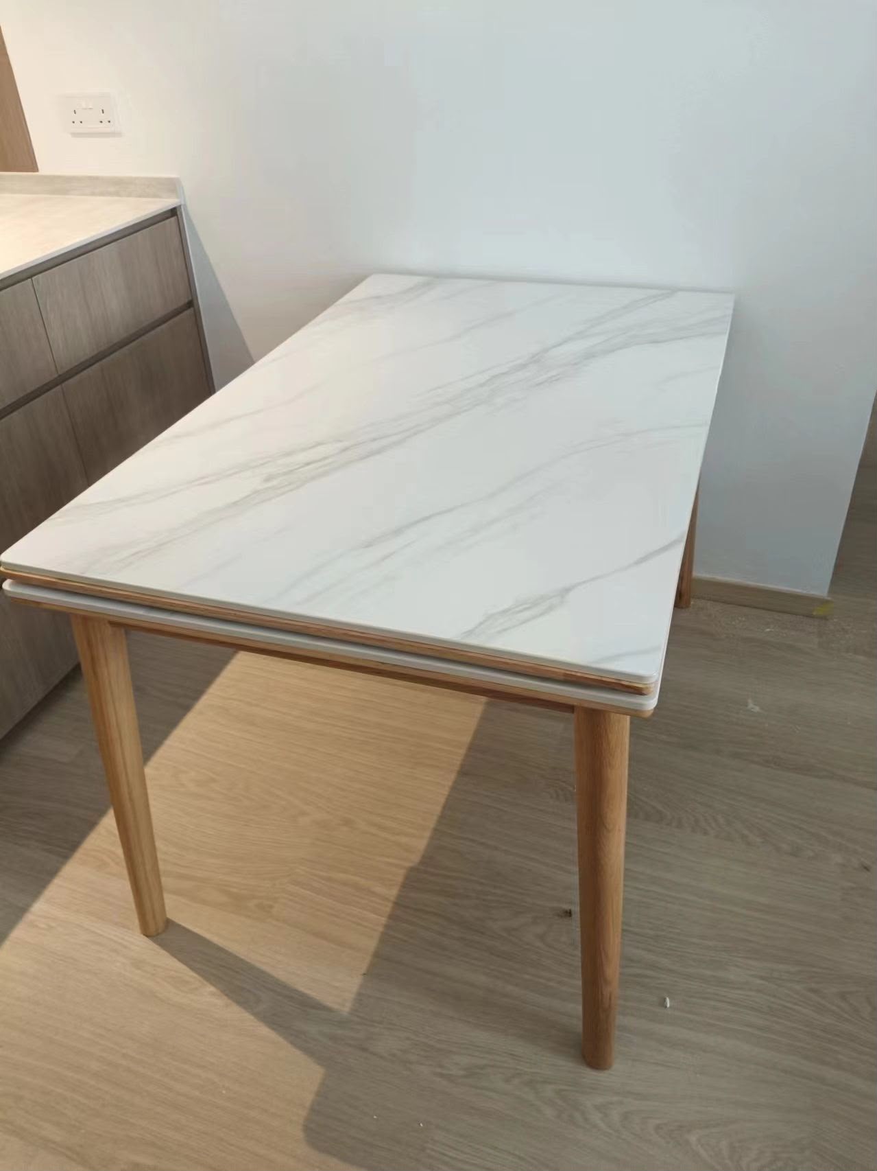 Marble-effect extendable dining table assembled by The Good Guys Singapore.