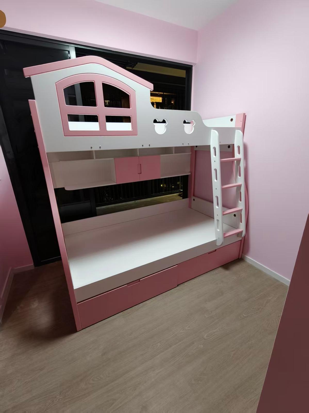Pink and white children's bunk bed with shelving and storage drawers assembled by The Good Guys Singapore.