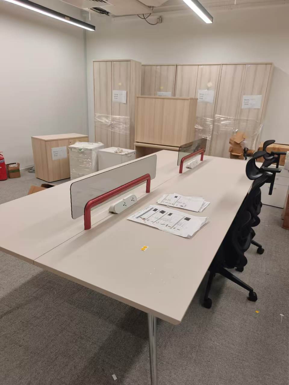 Shared office work desk with divider screens assembled by The Good Guys Singapore.