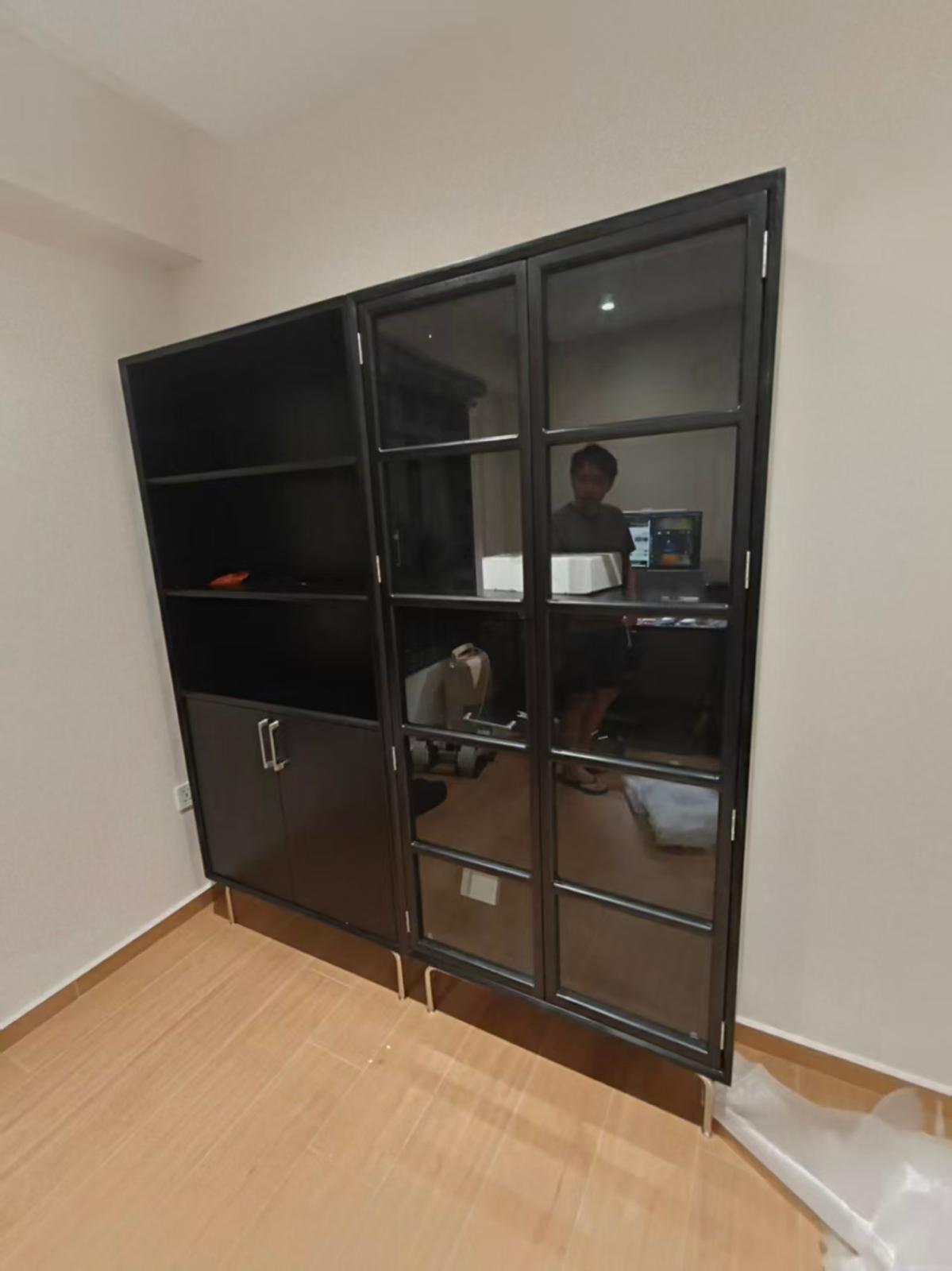 Tall dark display and storage cabinet with glass doors assembled by The Good Guys Singapore.