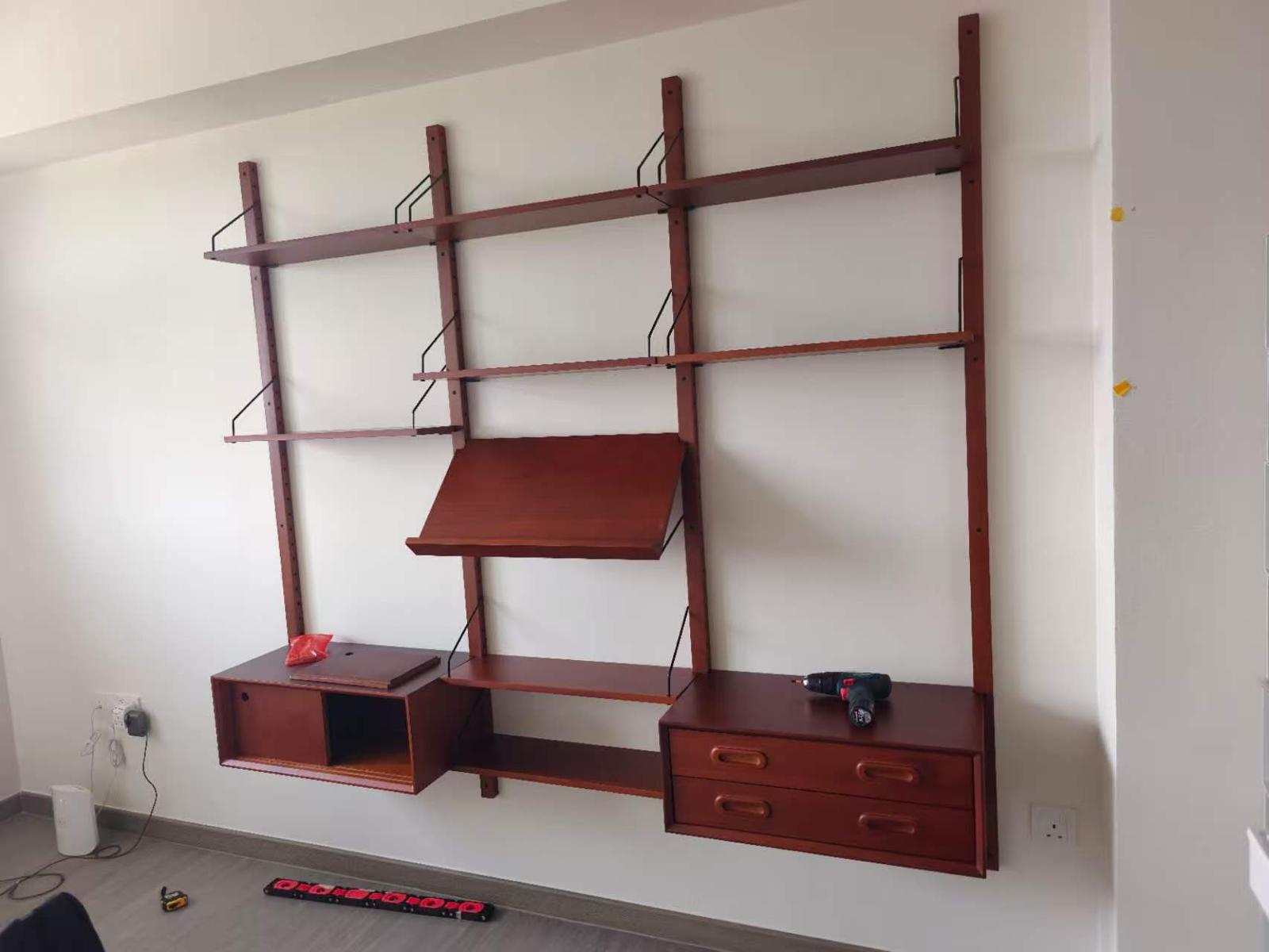 Wall-mounted shelving and desk system with drawers installed by The Good Guys Singapore.