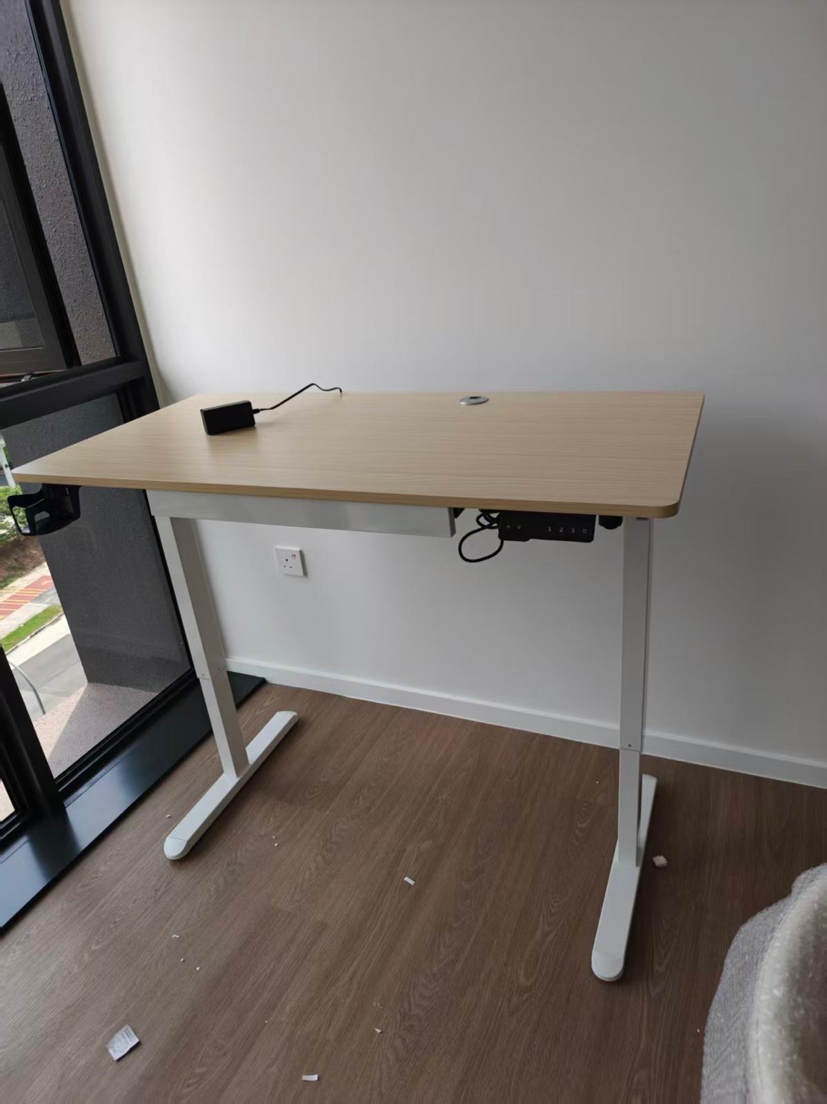 Height-adjustable work desk assembled by The Good Guys Singapore.