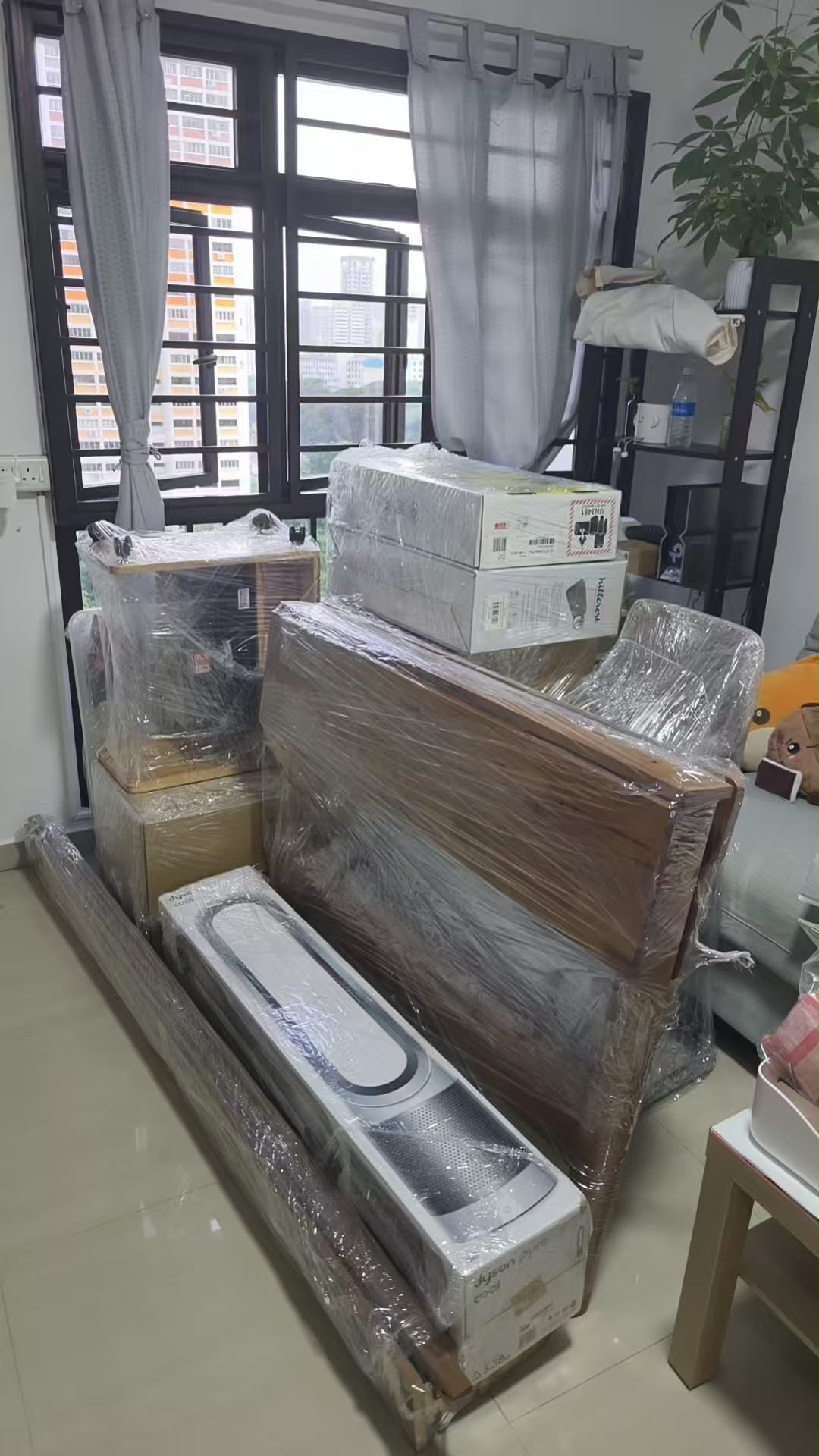 Furniture wrapped and stacked ready for a house move by The Good Guys Singapore.