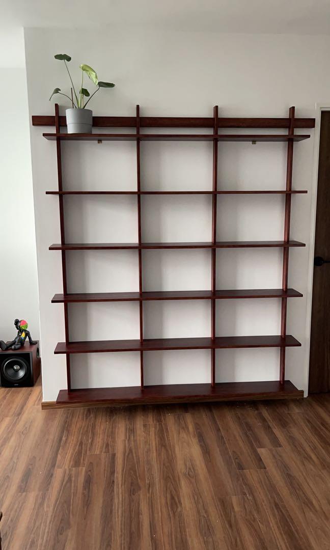 Large wooden wall-mounted shelving system installed by The Good Guys Singapore.